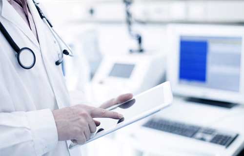 Doctor holding a tablet — Aurora, CO — The Sun Bus