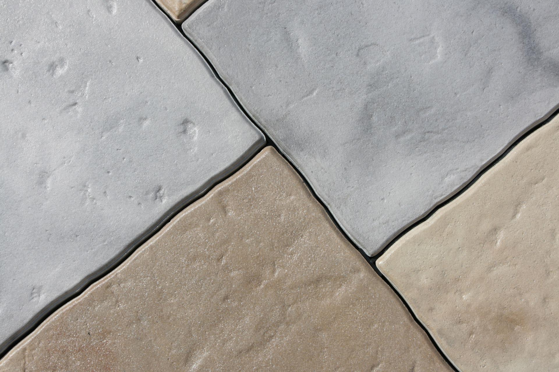 An intricately designed decorative concrete floor tile featuring geometric patterns and earthy colors.