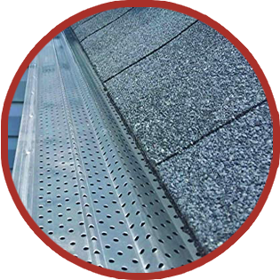 A close up of a gutter with a roof in the background.