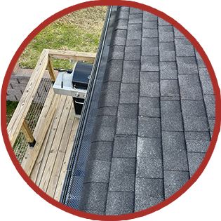 A roof with shingles and a grill on it.