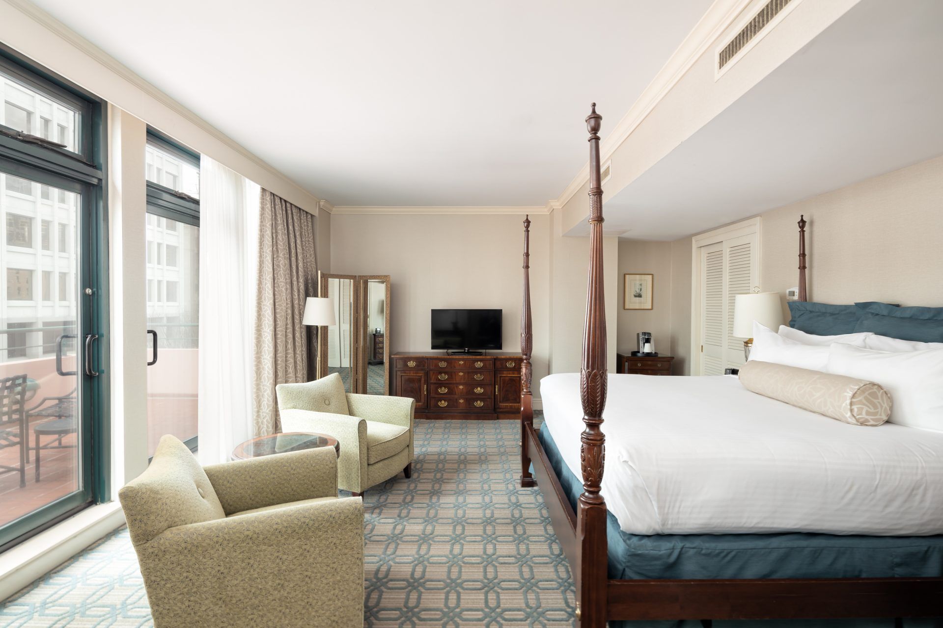 Governor's Suite king sized bed and seating area at The Berkeley Hotel in Richmond, Virginia