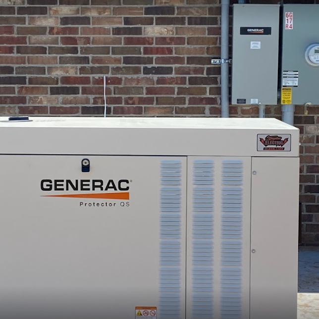 a generator is sitting in front of a brick wall
