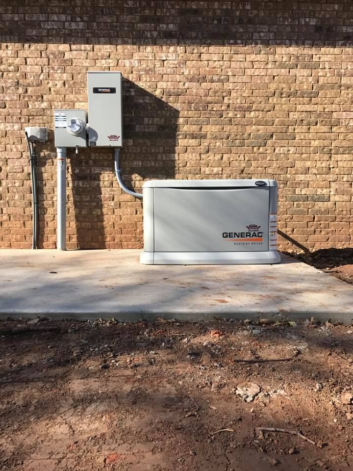 Generator Sitting on the Side of a Brick House