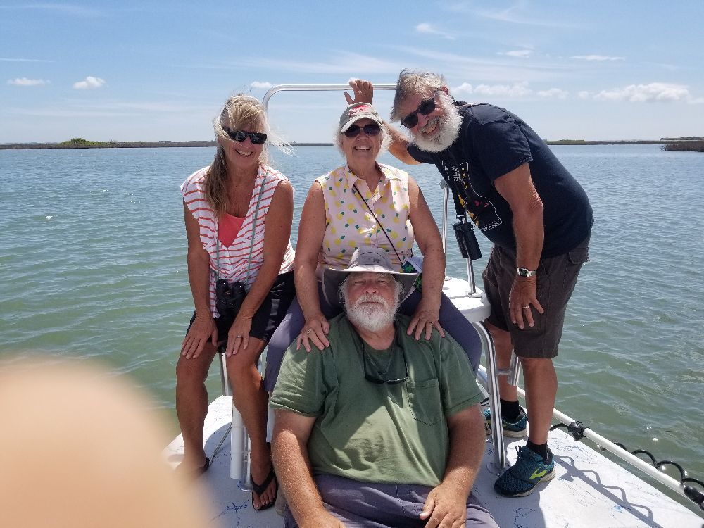 A man is sitting in a bus using a laptop computer.