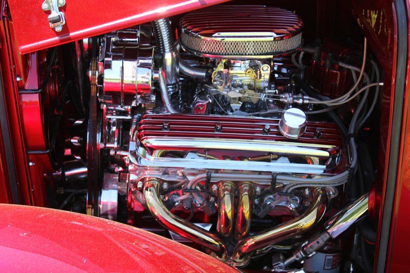 A close up of the engine of a red car