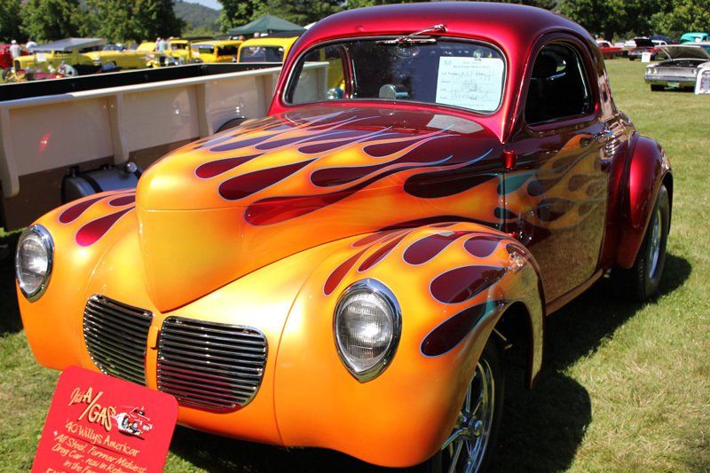 A red and orange car with flames painted on it