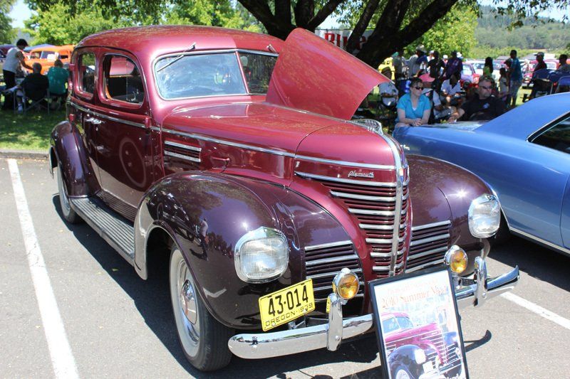 A red car with a license plate that says 43-014 is parked in a parking lot.