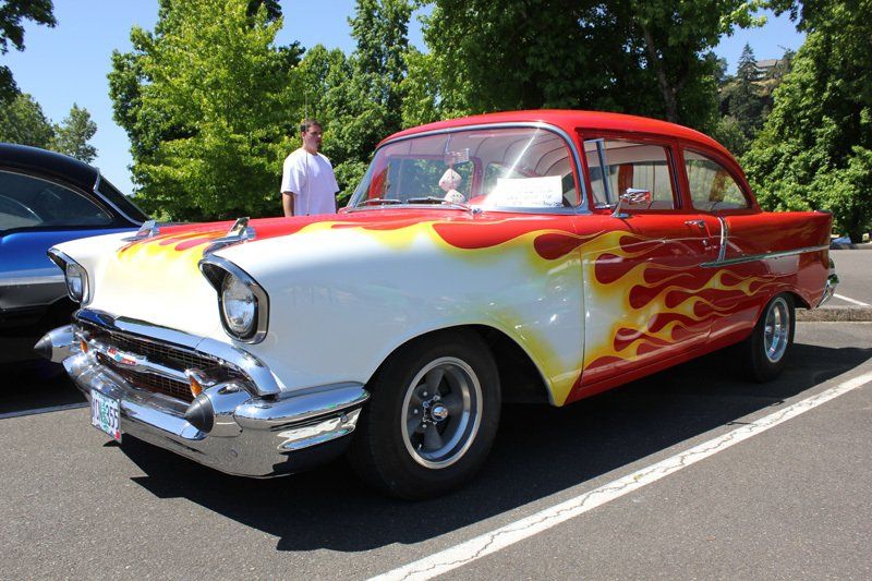 A red and white car with flames painted on it