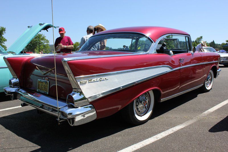 A red car is parked in a parking lot