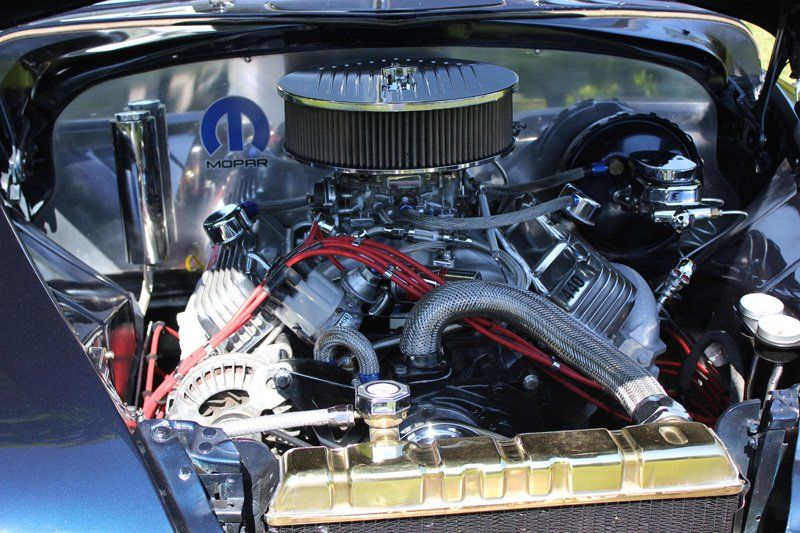 A close up of a car engine with a mopar logo on it
