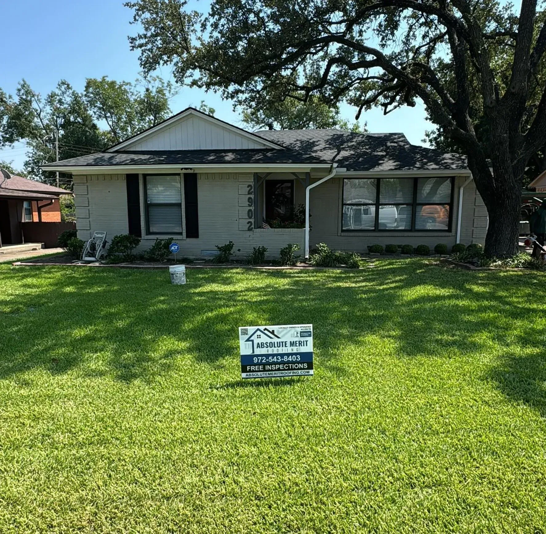 A house with a for sale sign in front of it