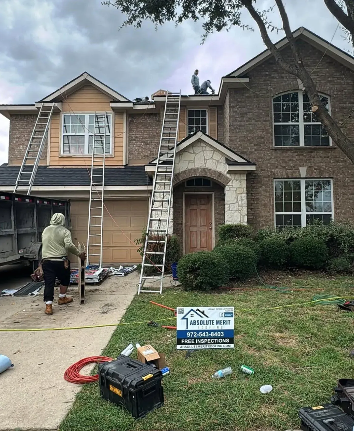A man is standing on the roof of a house.