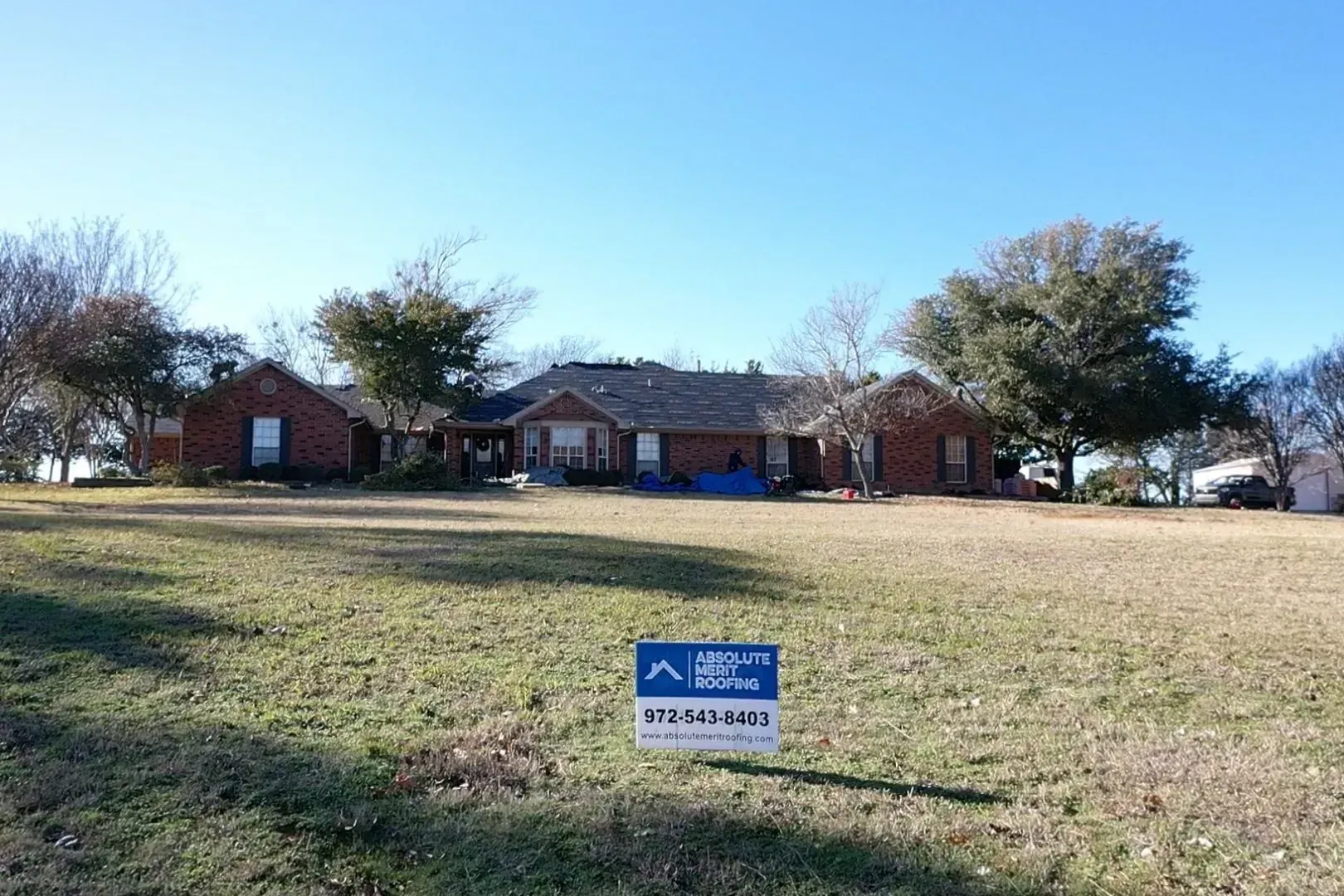A house with a for sale sign in front of it