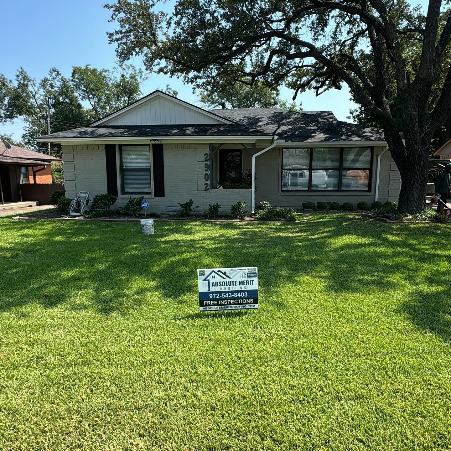 A house with a for sale sign in front of it