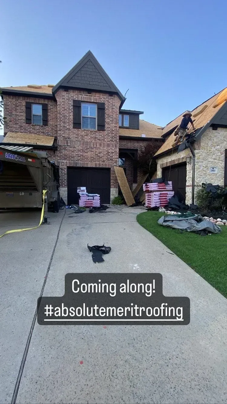 A large brick house with a roof being installed.