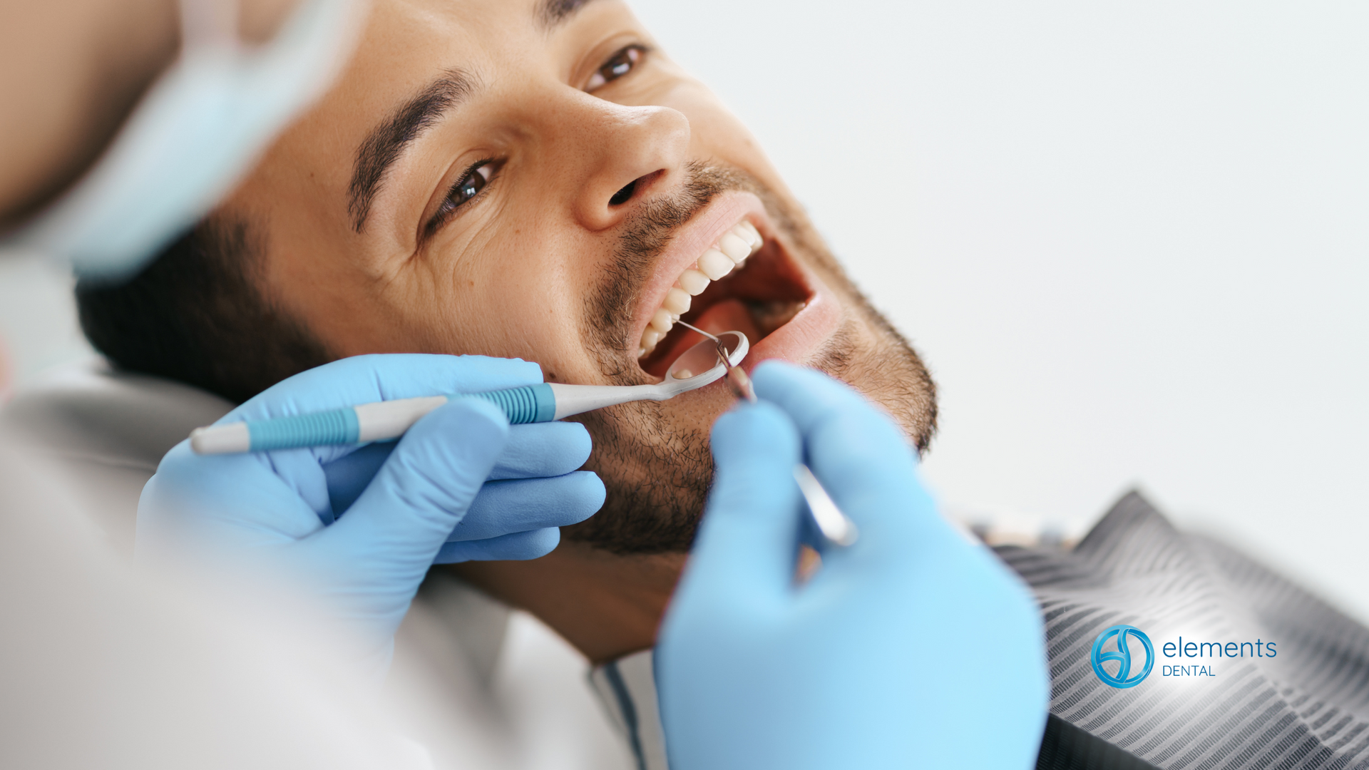 A man is getting his teeth examined by a dentist.