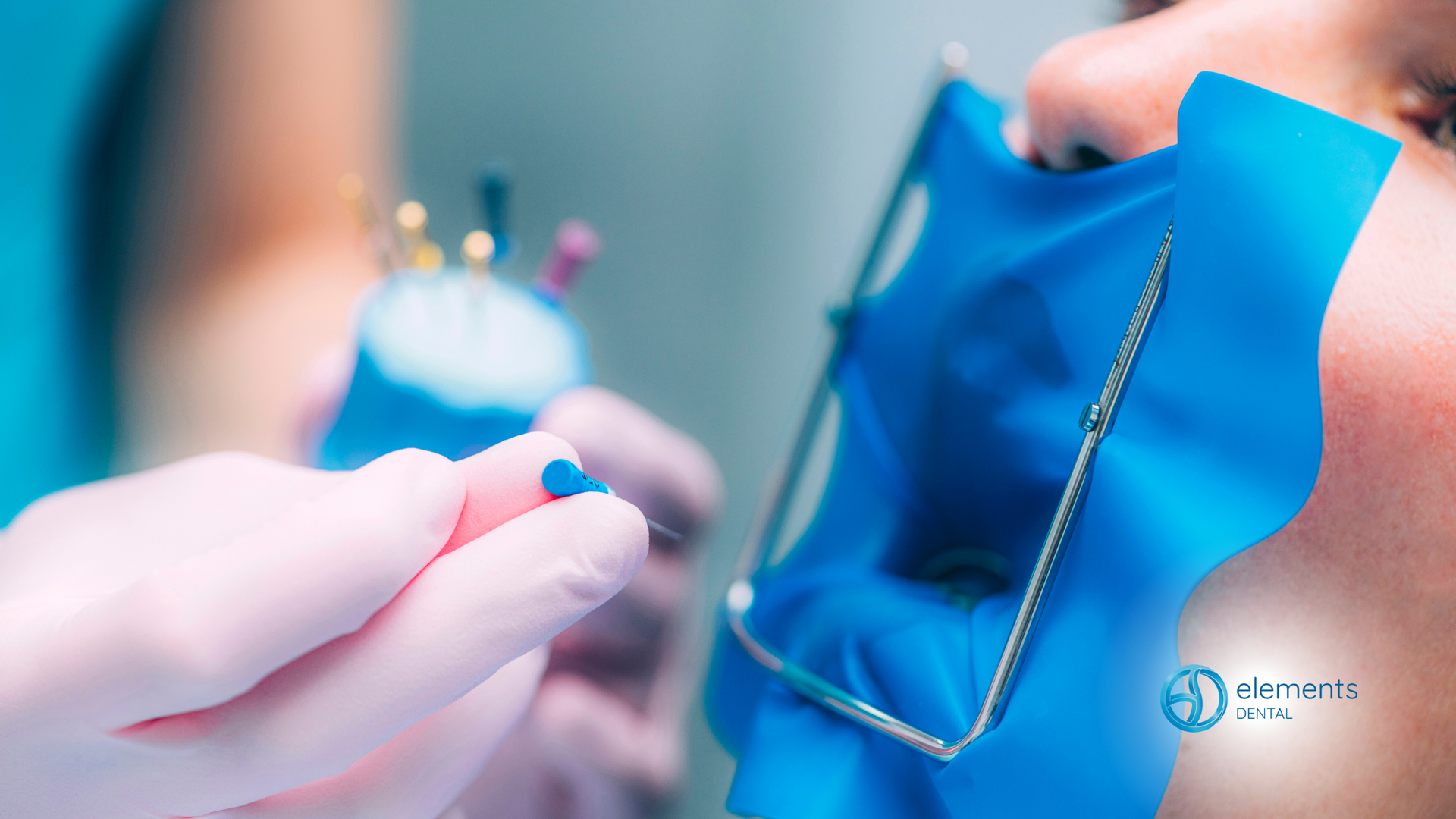 A dentist is holding a blue object in front of a patient 's mouth.