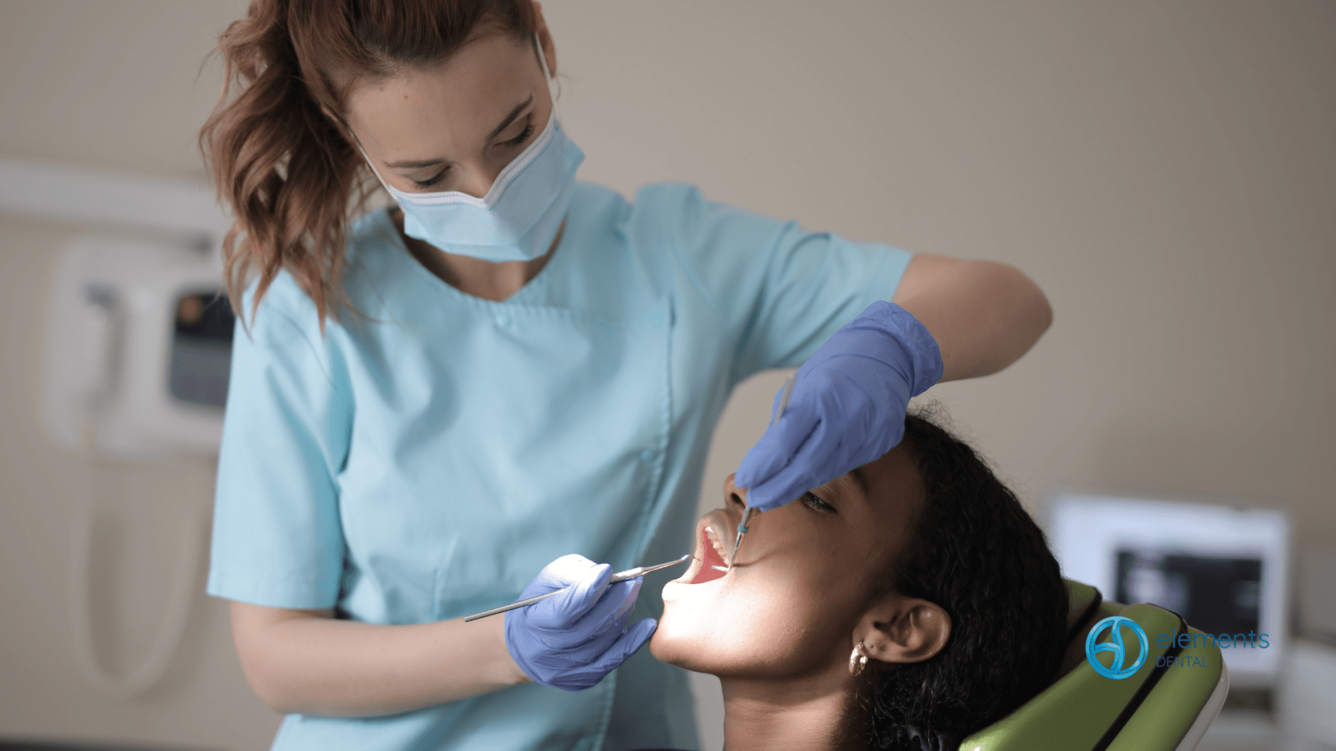 A woman is sitting in a dental chair while a dentist examines her teeth.