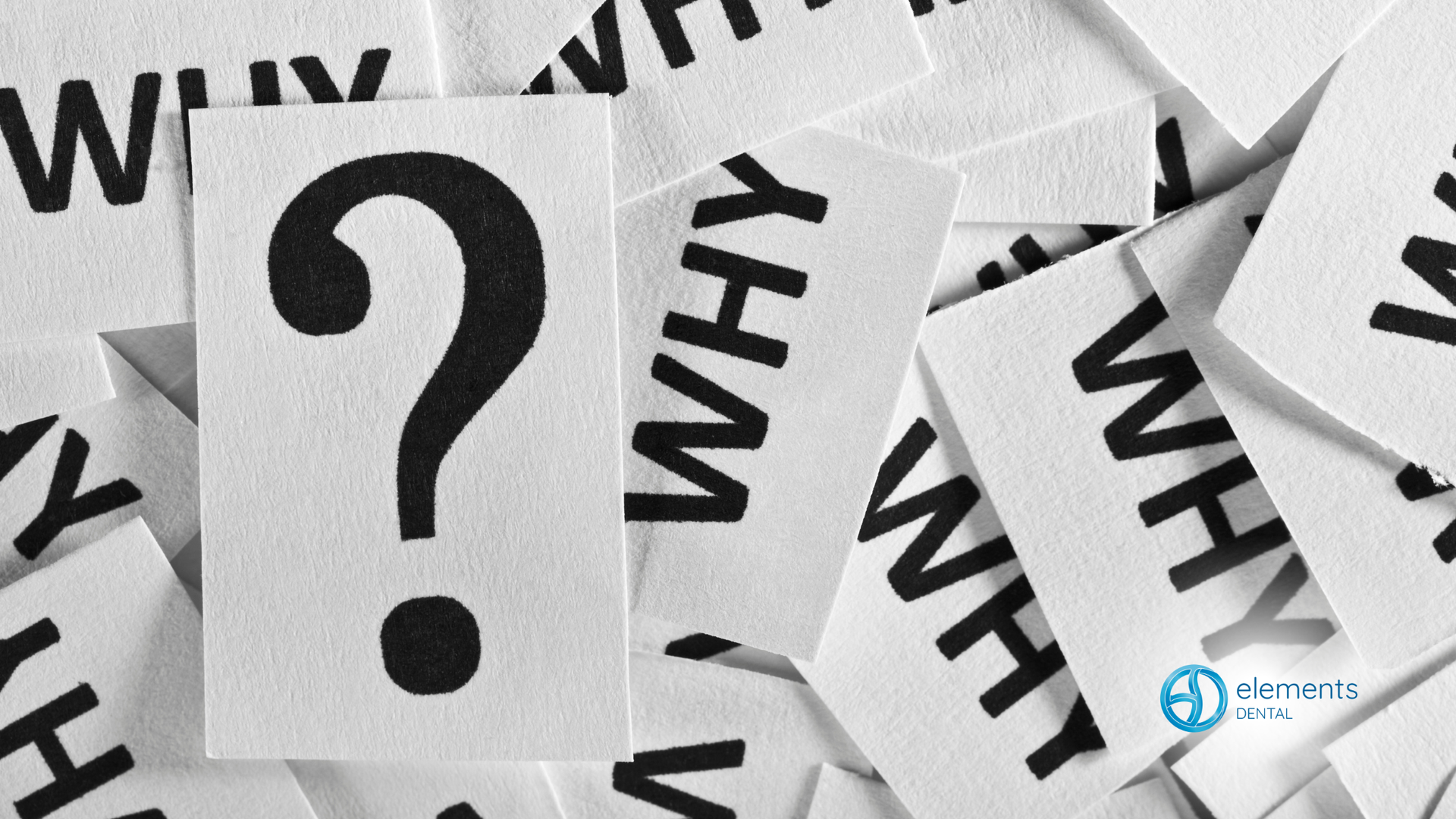 Large question mark on a white card, surrounded by smaller cards with