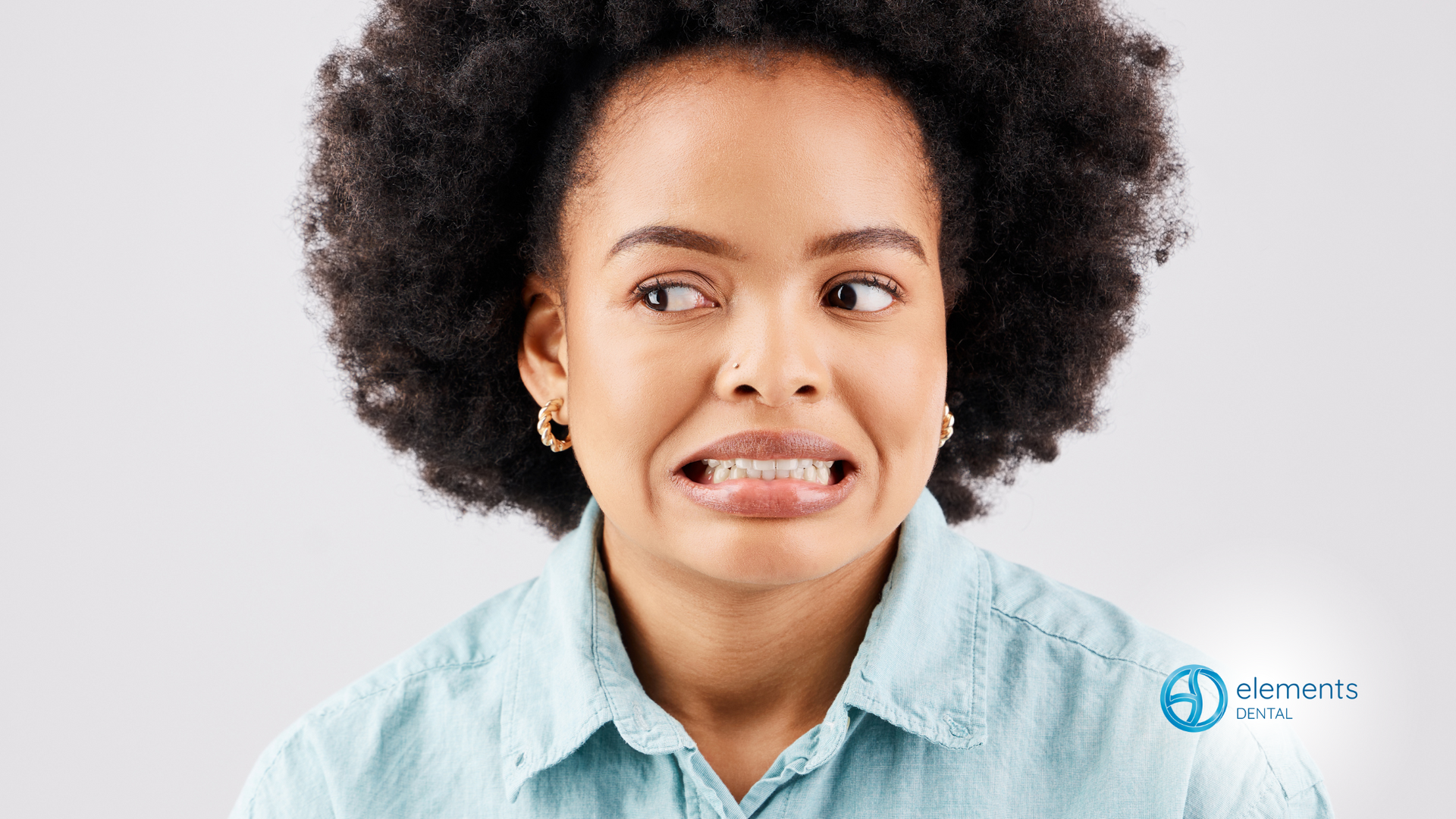 A woman with braces on her teeth is making a funny face.