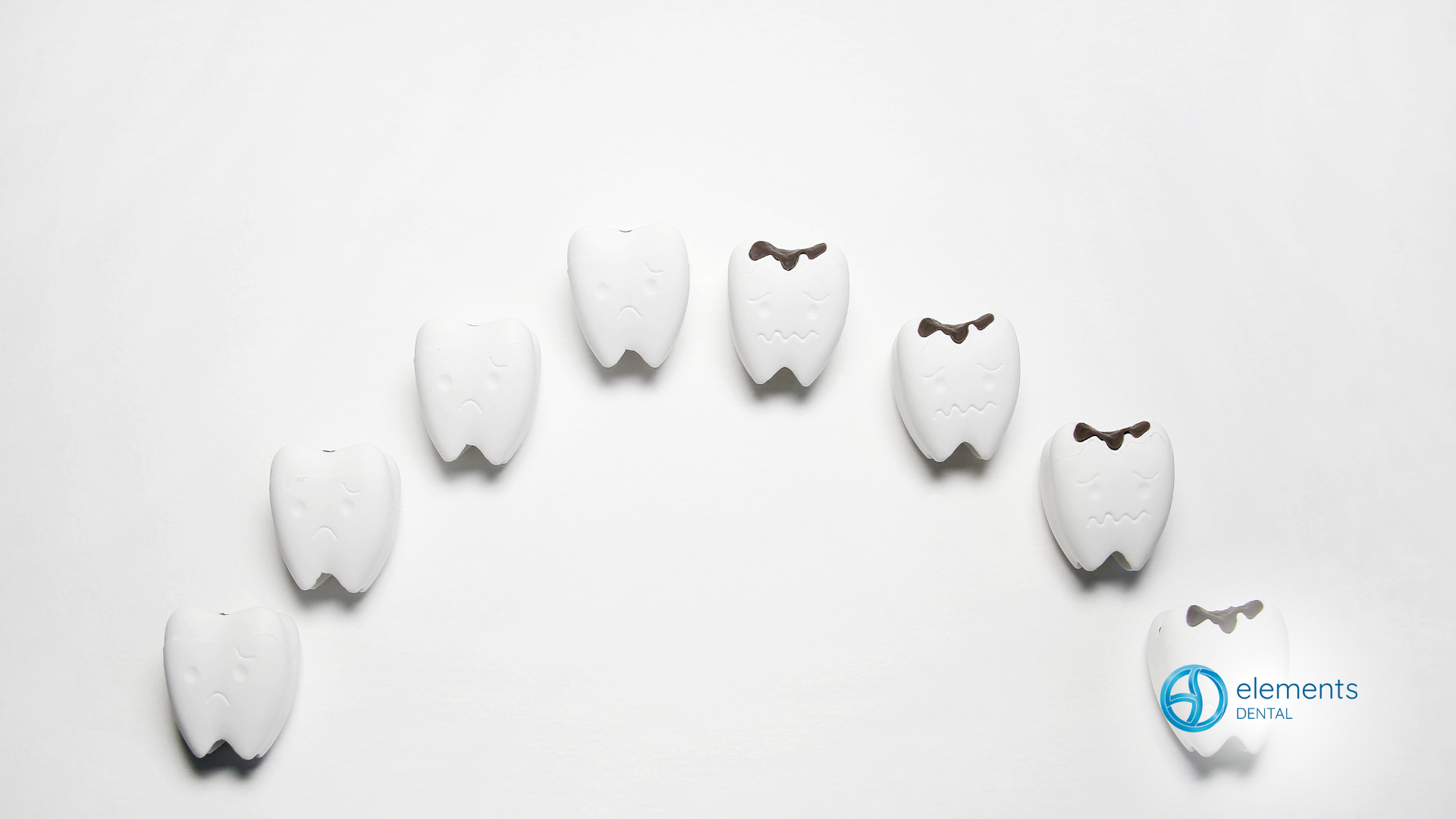 A row of teeth are lined up in a circle on a white background