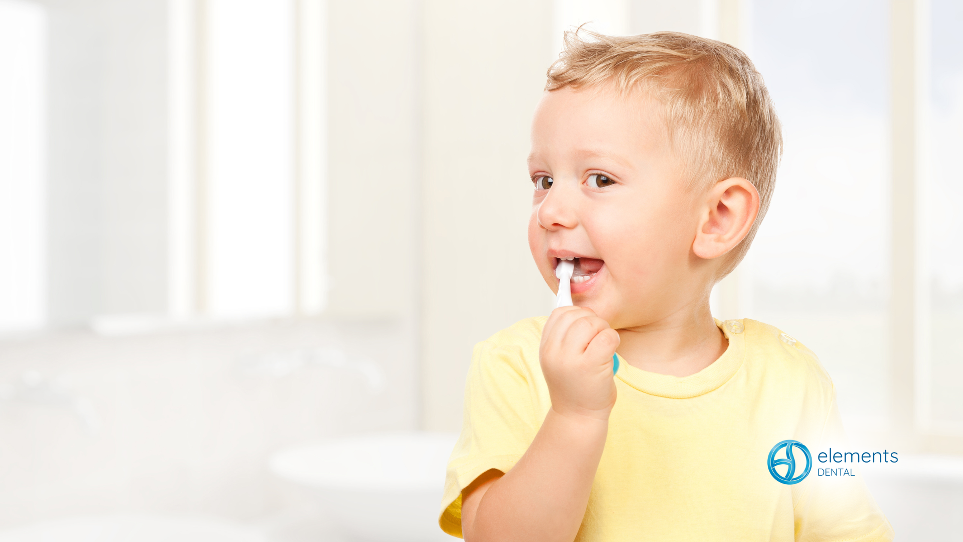 Child brushing teeth in a bright bathroom with a window; yellow shirt.
