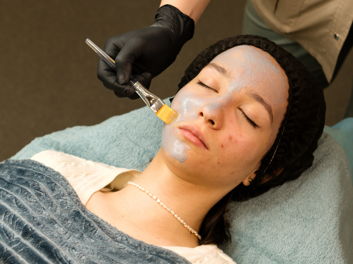 A woman getting an acne facial treatment