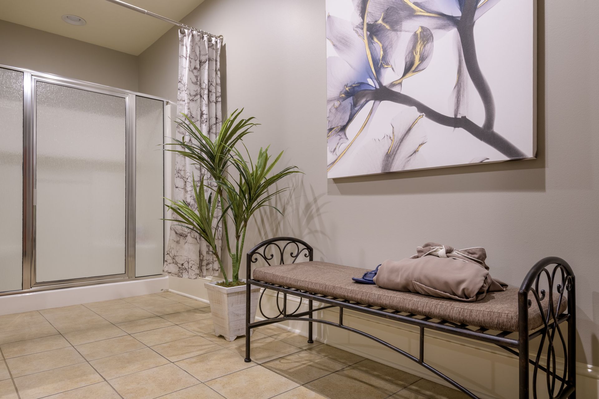 A bathroom with a bench and a painting on the wall