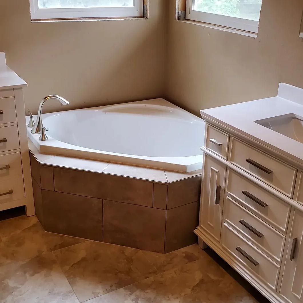 A bathroom with a jacuzzi tub and a sink