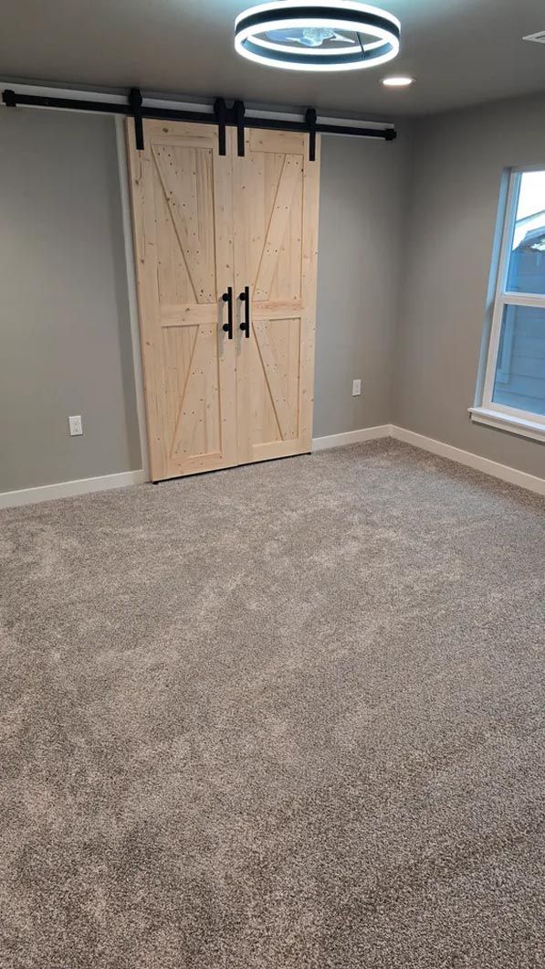 There are two sliding barn doors in the room.