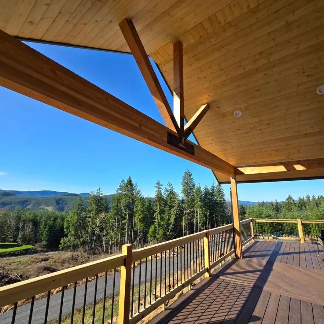 A wooden deck with a view of a forest