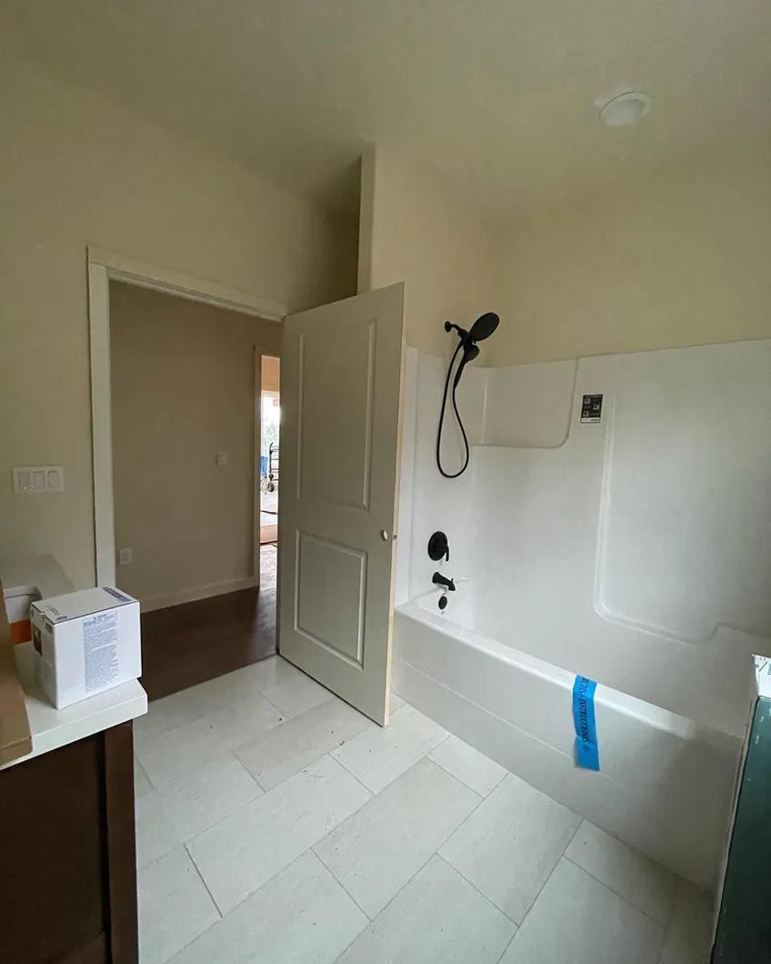 A bathroom with a bathtub and a shower.