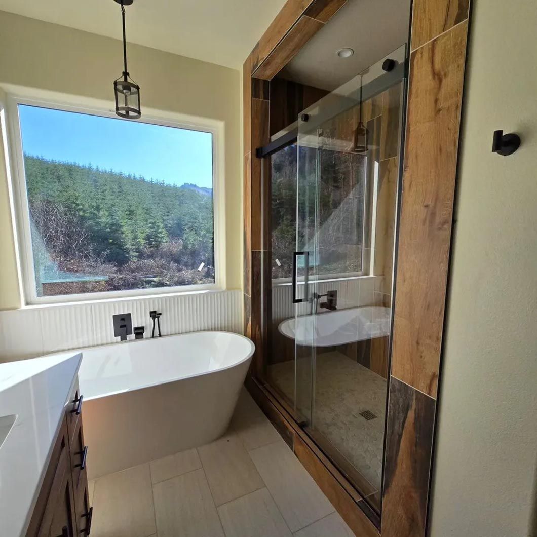 A bathroom with a tub , shower and window.