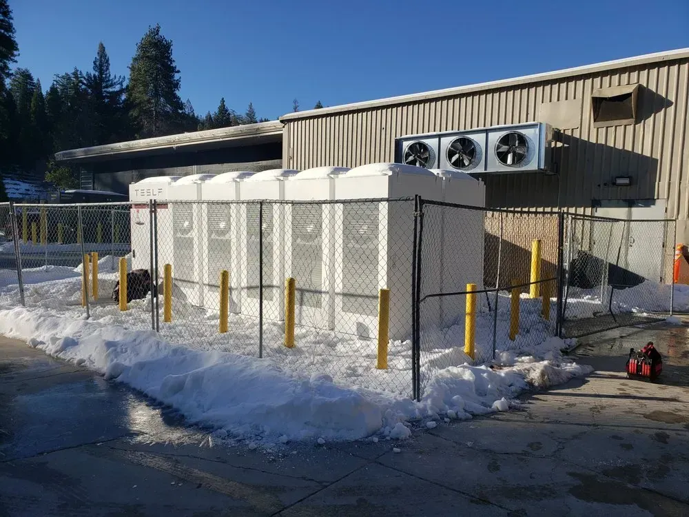 A building with a fence and a lot of snow on the ground
