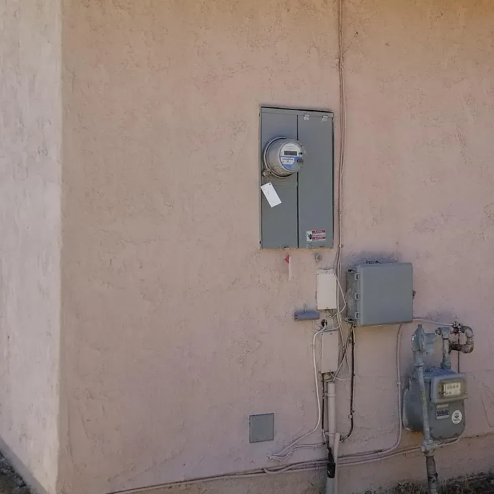 There is a meter on the side of a building.