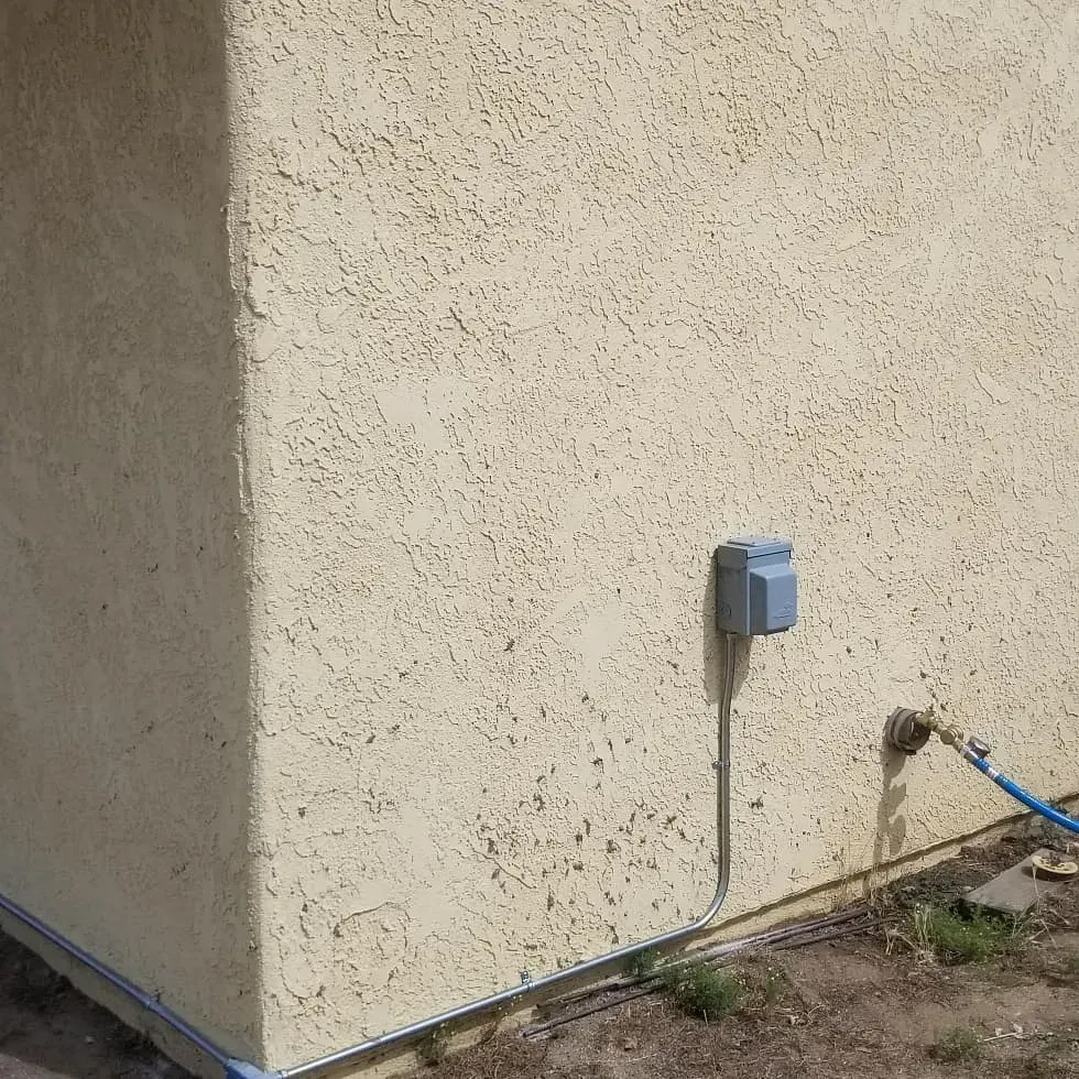 A hose is attached to the side of a building