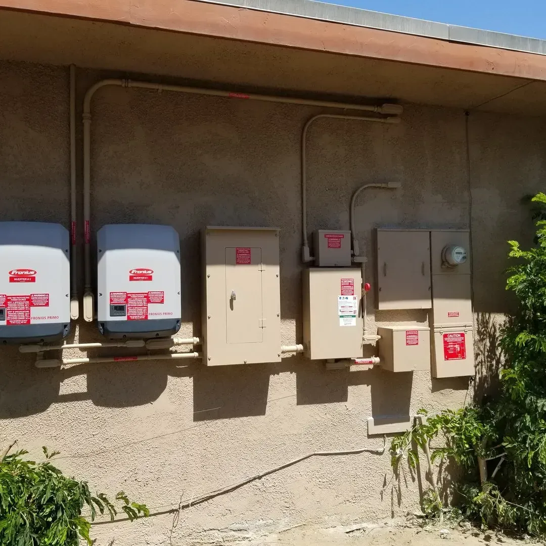 A row of electrical boxes on the side of a building
