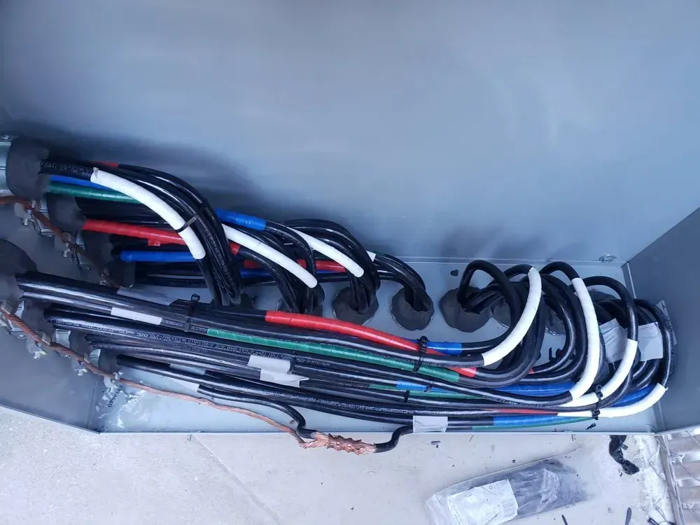 A bunch of wires are laying on the floor in a box