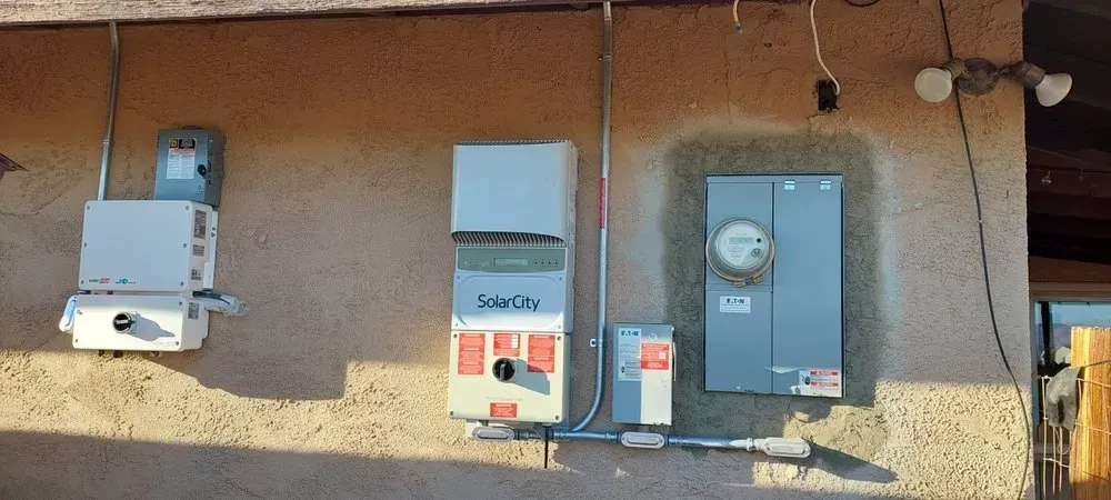 A wall with a lot of electrical equipment on it
