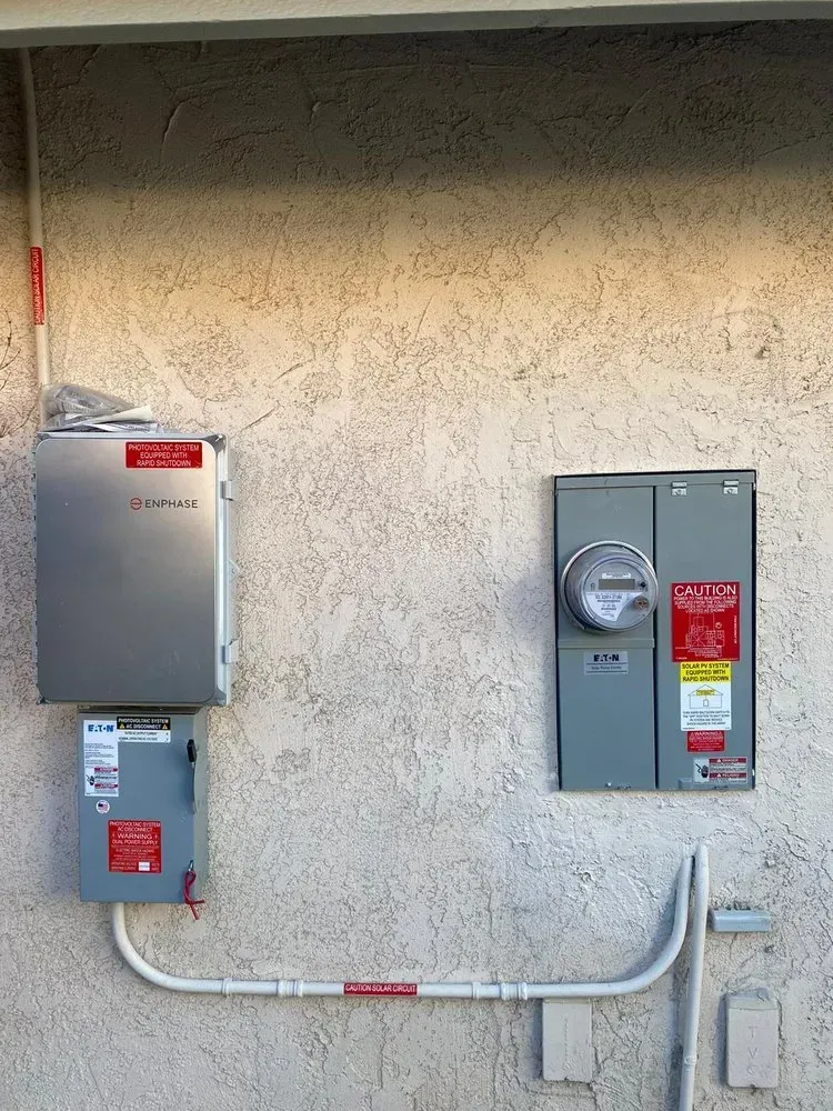 A wall with electrical boxes and a meter on it