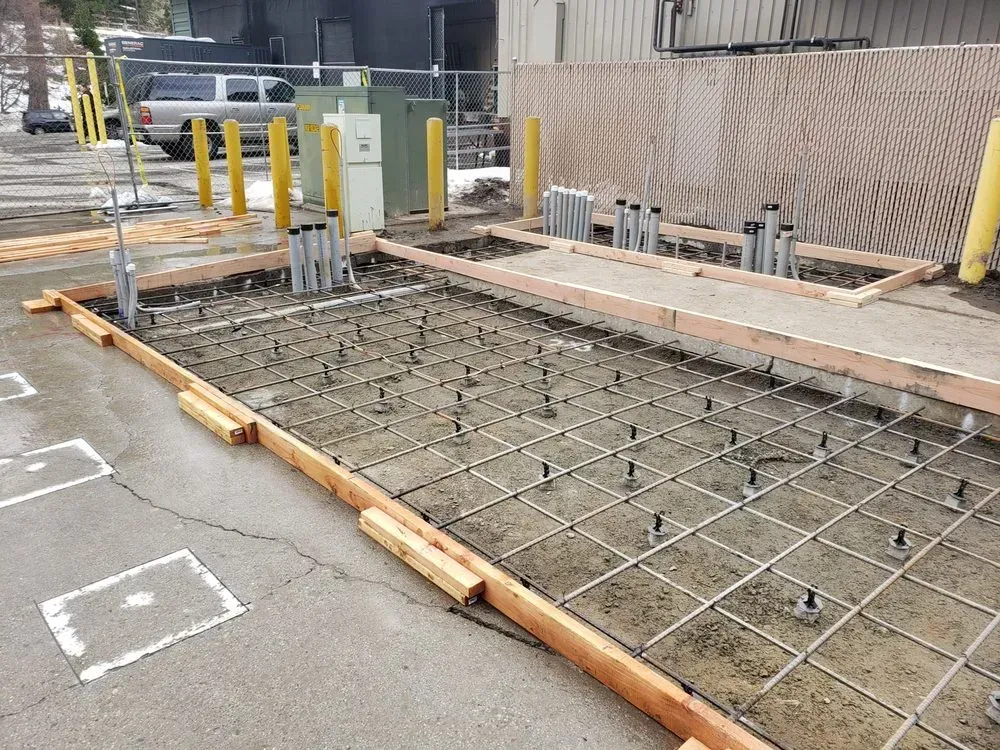 A concrete slab is being built in a parking lot