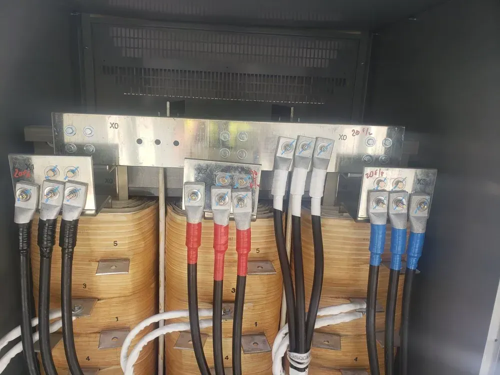A bunch of wires are connected to a transformer in a box.