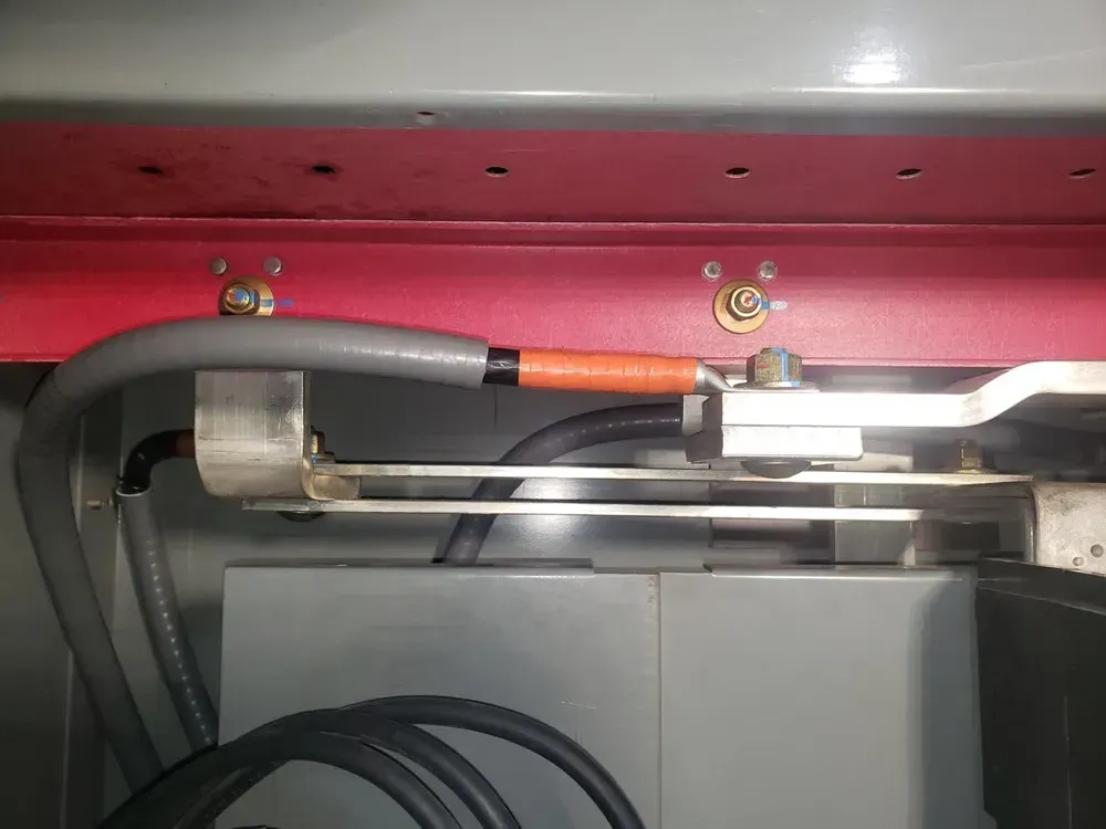 A bunch of wires are connected to a machine in a room.