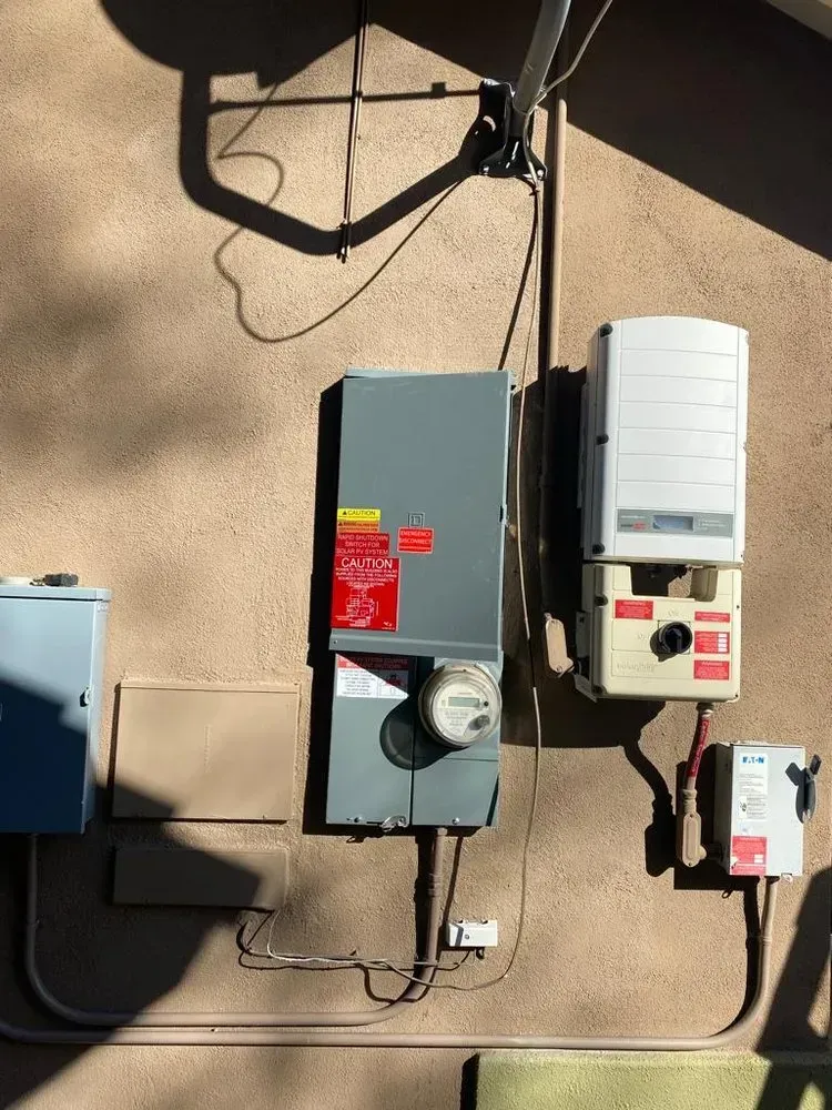 A solar panel is mounted on the side of a building.