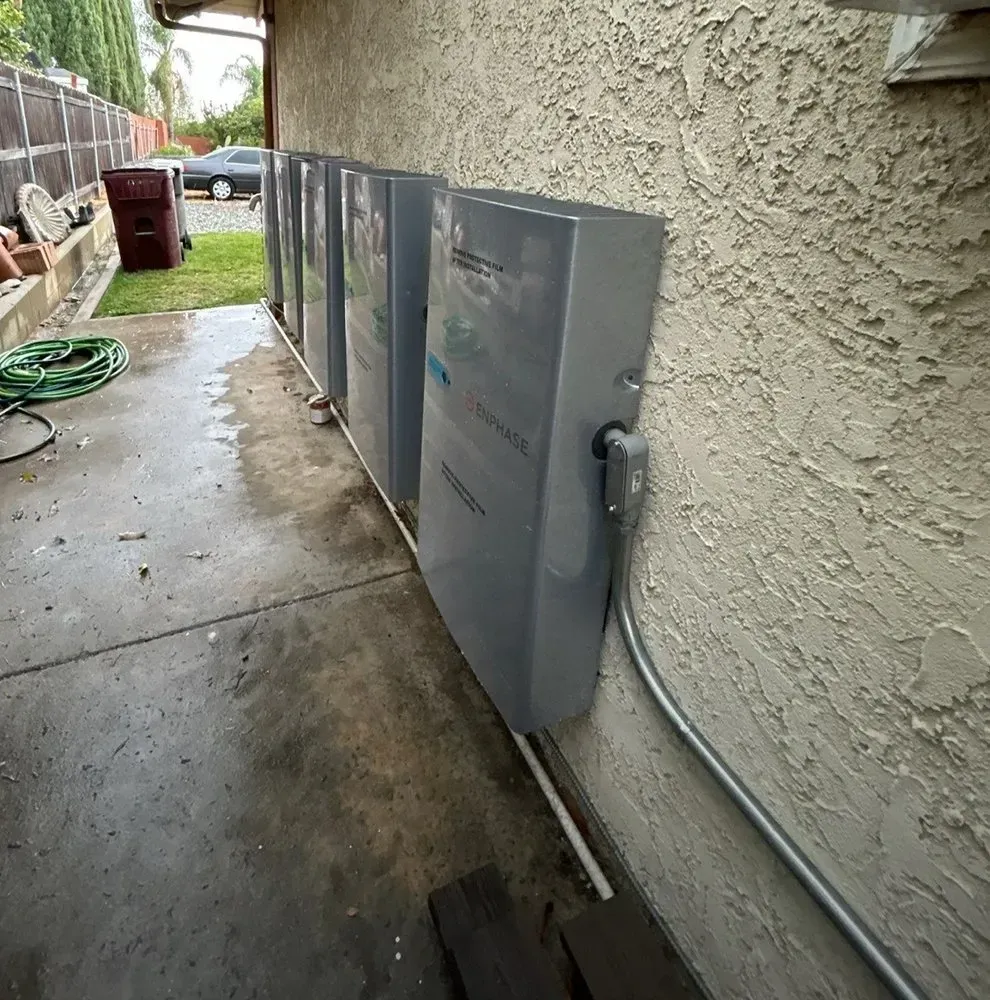 A row of electrical boxes on the side of a building