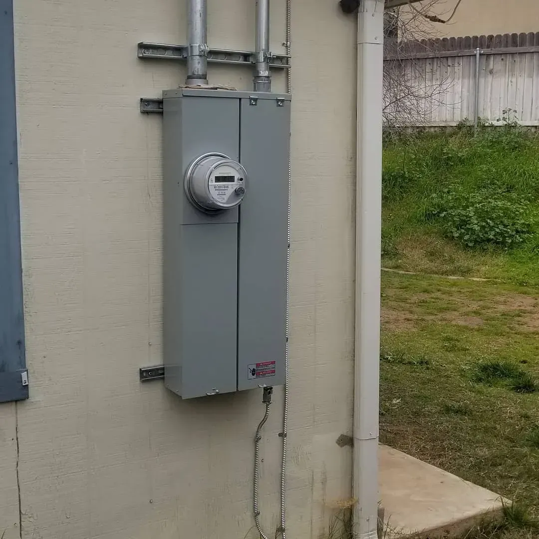 There is a meter on the side of a building.