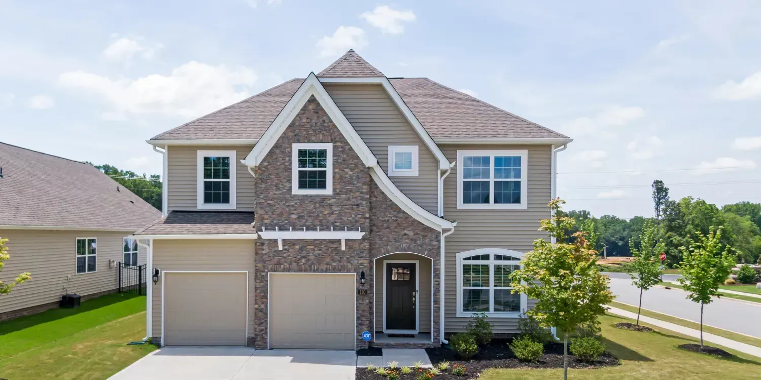 A large house with a lot of windows and a large garage.