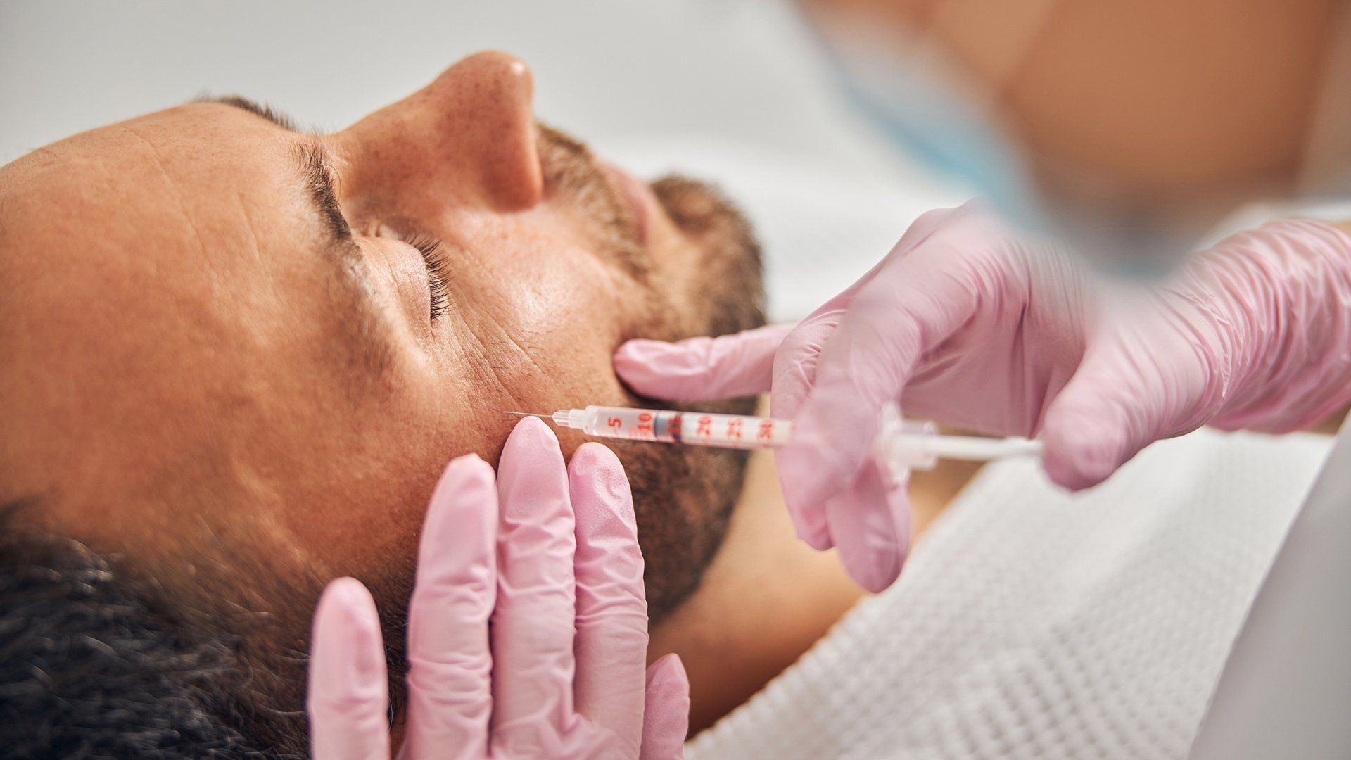 Injecting On Man Face — Redlands, CA — Aesthetic Skin And Laser