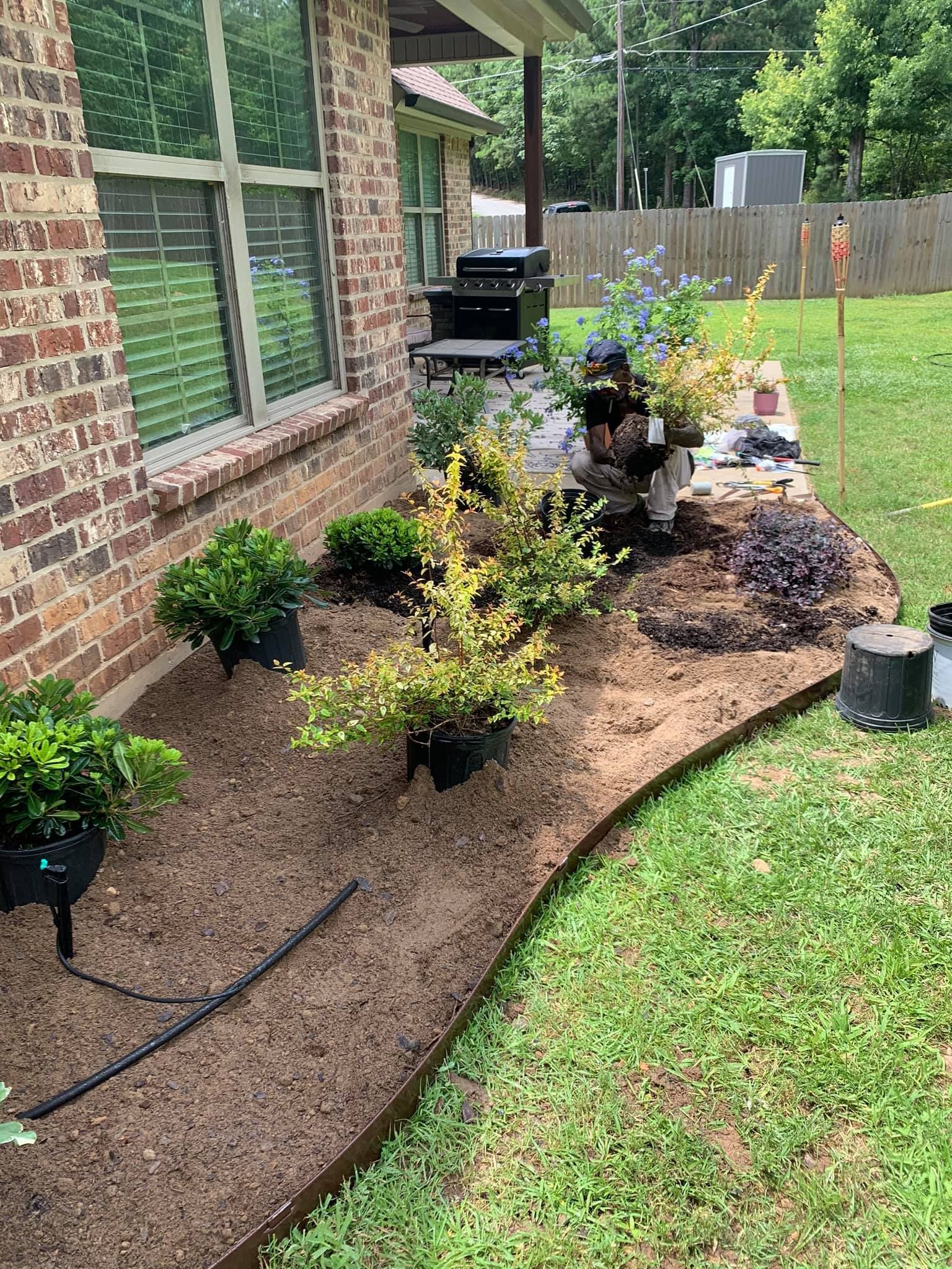 A brick house with a garden in front of it.