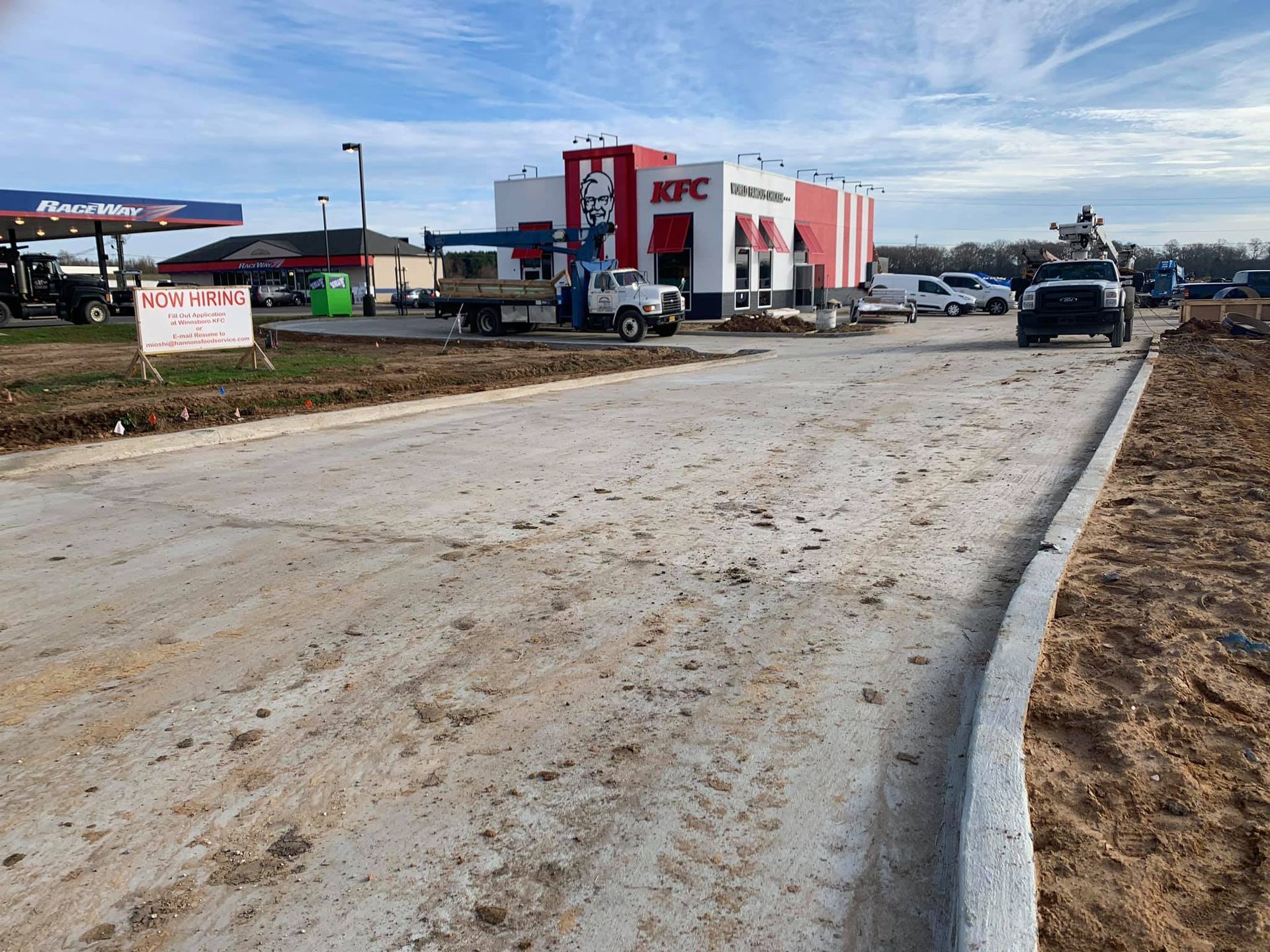 A kfc restaurant is being built on a dirt road